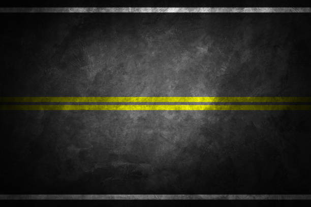 istock Structure of granular asphalt. Asphalt texture with two yellow line road marking. Abstract road background. 1147892696