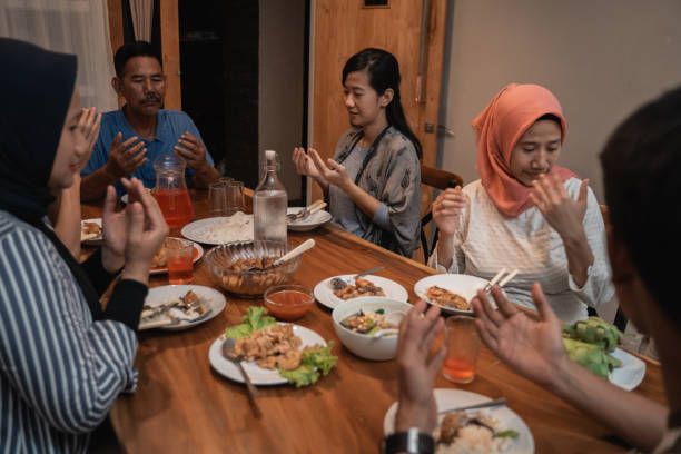 istock muslim family pray before dinner 1147892748