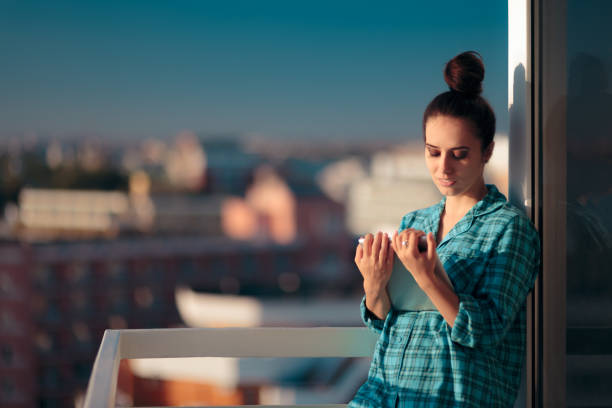 istock Woman in Pajamas with PC Tablet Starting her Morning Routine 1147892780