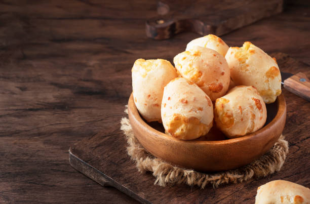 istock Cheese buns in wooden bowl, rustic kitchen table 1147899642