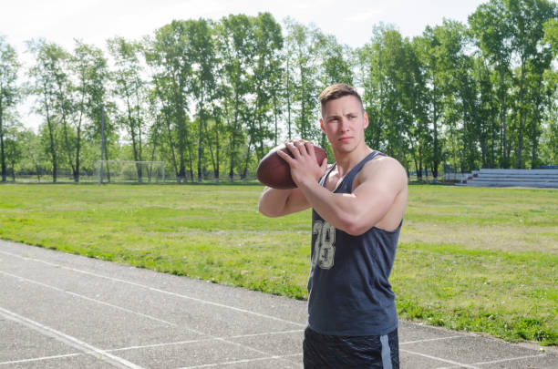 istock Portrait of a young quarterback with a ball 1147901854