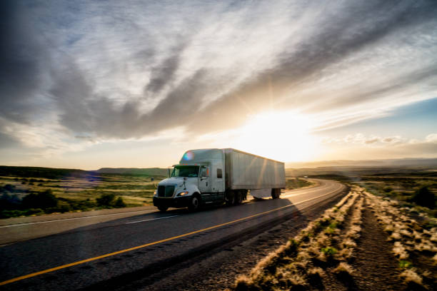 istock Long Haul Semi Truck on a Highway at Dusk under a Dramatic Sky 1147902591