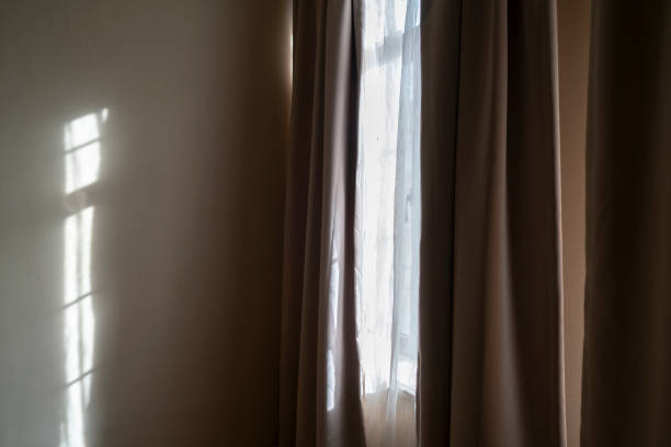 istock window,curtain and sunlight in morning 1147904542