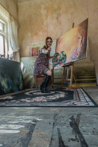 Young Woman Artist Doing Paintings in Victorian Style Home Studio