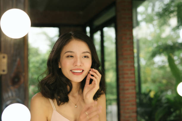 istock Young woman looking herself reflection in mirror at home 1147909600