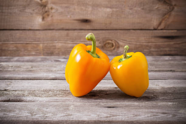 istock pepper on old wooden background 1147913645