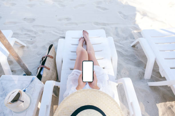 istock a woman holding and using white mobile phone with blank desktop screen 1147917237