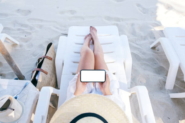 istock a woman holding and using white mobile phone with blank desktop screen 1147917260