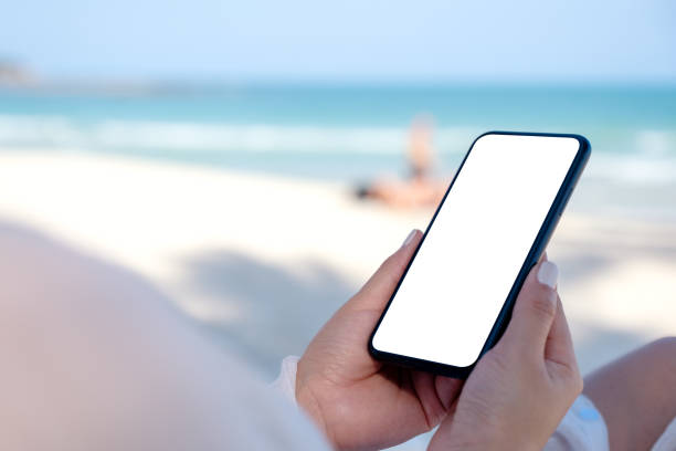 istock A woman holding white mobile phone with blank desktop screen 1147917295