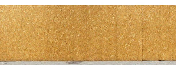 Construction site yellow fence is made of wooden resin-impregnated chipboards. Isolated stock photo