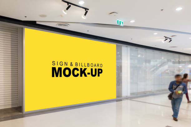 Mock up blank large billboard and blurred passer Mock up blank large billboard with clipping path in hall and blurred passer, Empty yellow screen space for advertising or information, business marketing and advertising concept pixs stock pictures, royalty-free photos & images