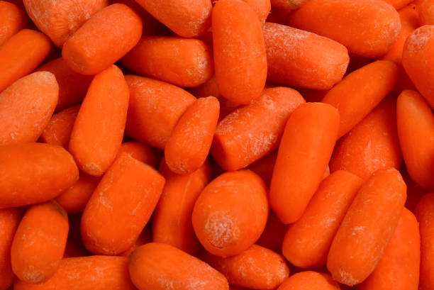 istock Little fresh carrots as a background. Snack. 1147924900
