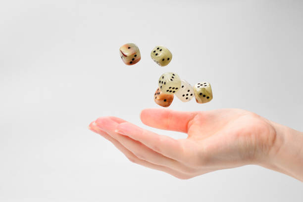 istock Woman throws dices isolated on white. 1147924940