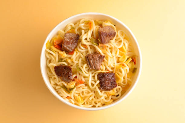 istock Paper cup with instant ramen noodles with beef and vegetables. 1147924957