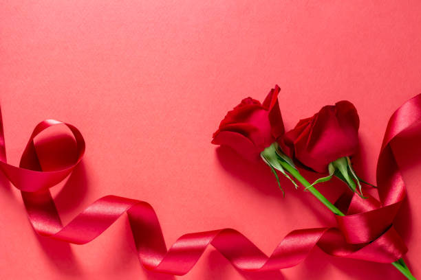 istock Image of red rose and red ribbon present 1147925007