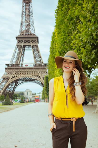 istock smiling young traveller woman speaking on cell phone 1147925457