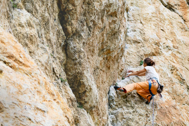 istock Woman climbs mountain. 1147926108