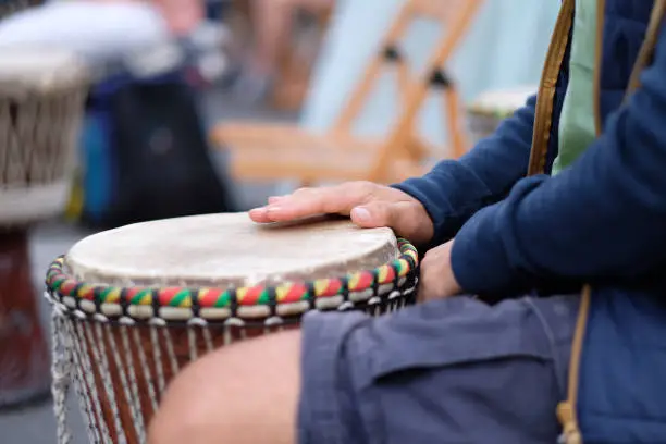 Photo of A musician playing on an African djembe drum