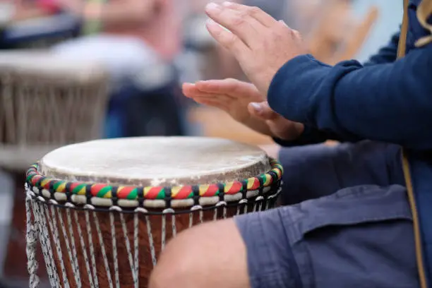 Photo of A musician playing on an African djembe drum