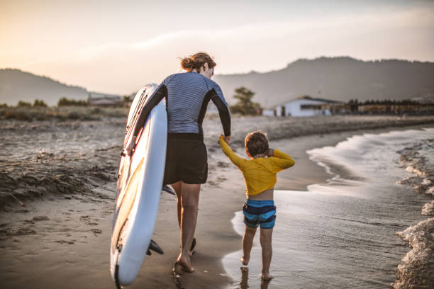 istock Family surfers at the beach 1147926298