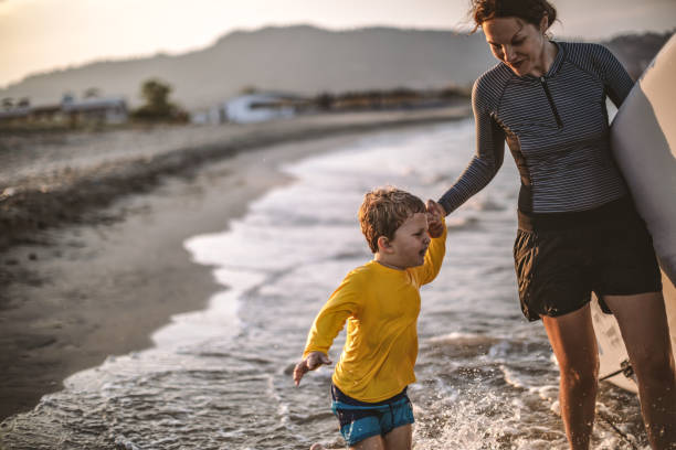 istock Family surfers at the beach 1147926336