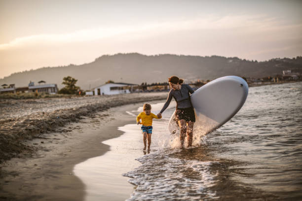 istock Family surfers at the beach 1147926366