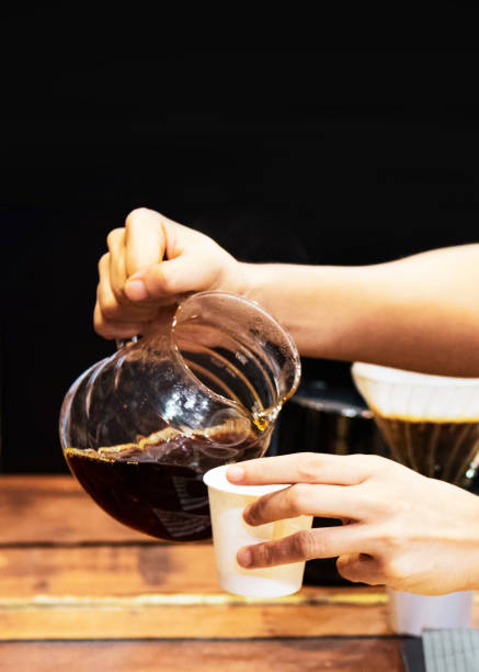 istock Barista making coffee, Barista pouring drip coffee into glass 1147926549