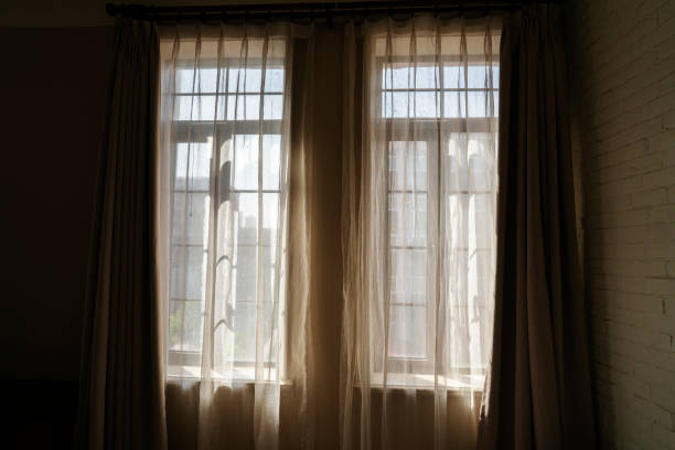 istock window,curtain and sunlight in morning 1147927541