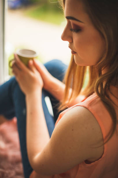 istock Young woman with coffee 1147929139