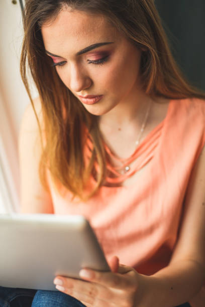 istock Young girl looking at digital tablet 1147929212