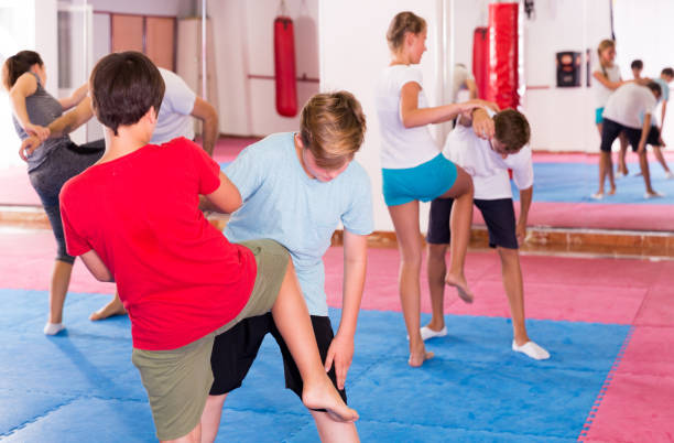 istock Kids exercising self-defense movements 1147931120