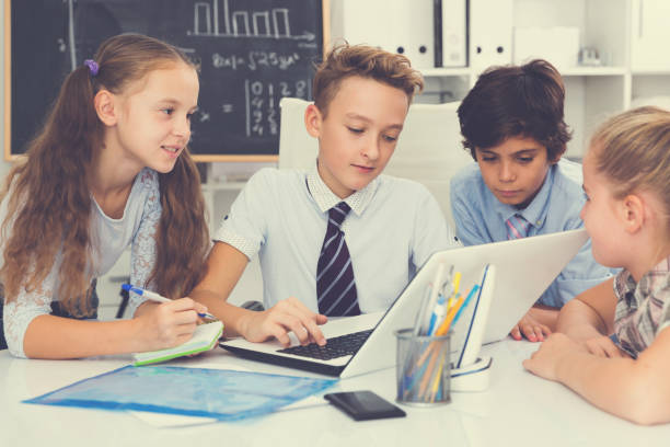 istock children near laptop talking about mathematics 1147931505