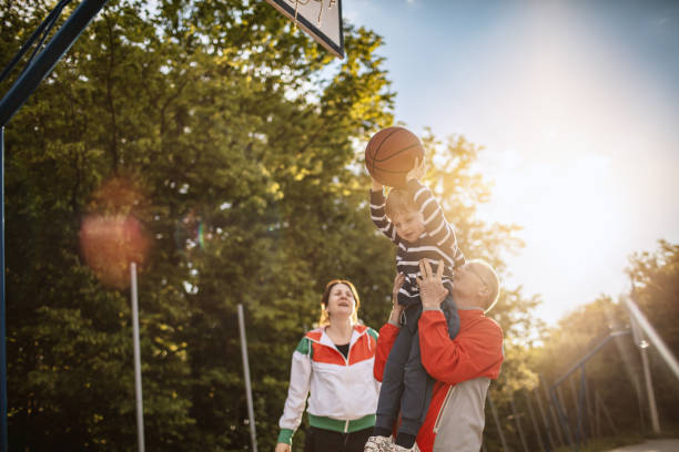 istock Multigeneration family playing basketball 1147932684