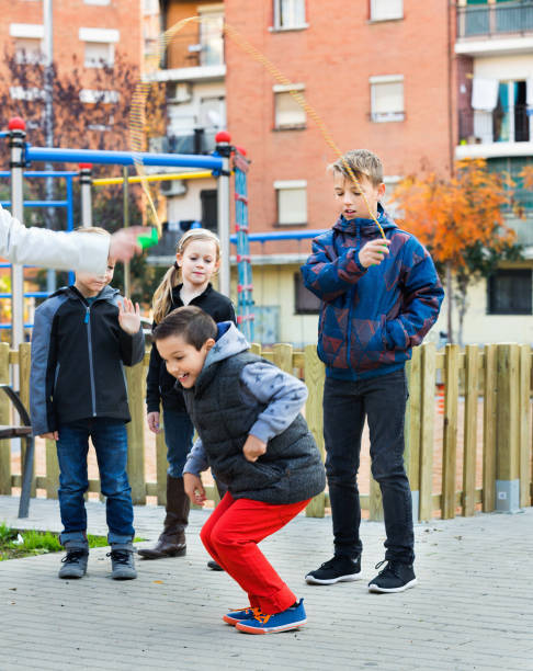 istock Positive kids playing in jump rope game 1147932914