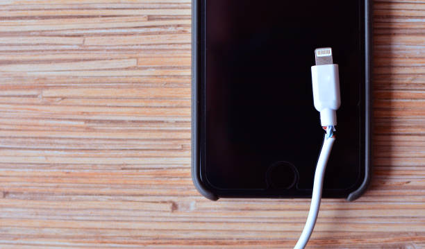 istock Phone repair background with a broken cable and smartphone 1147933082