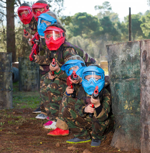 istock Group of lucky kids playing paintball 1147934430
