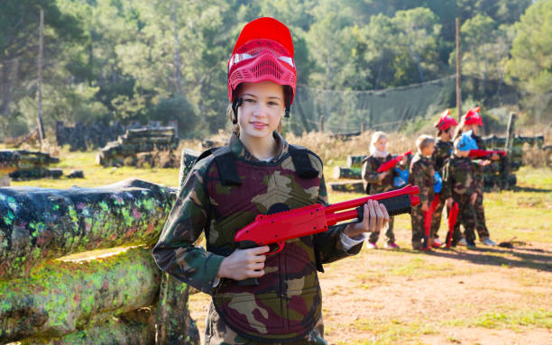istock girl paintball player in camouflage standing 1147934442