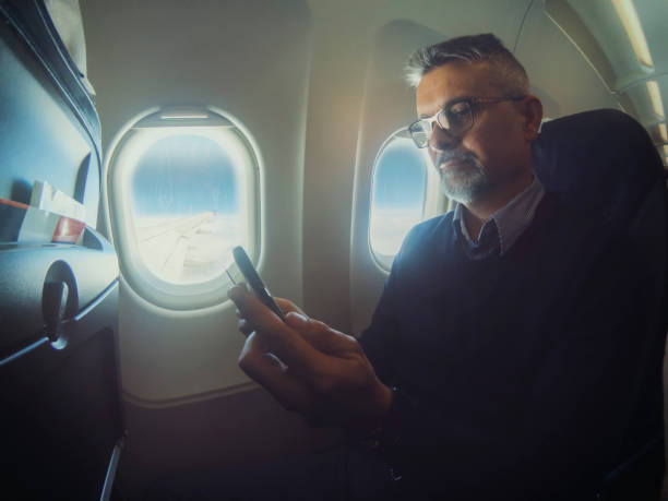 istock Business man at airplane 1147941675