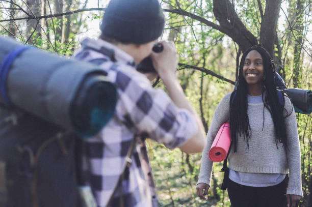 istock Mixed race couple, campers walking through forest 1147943942