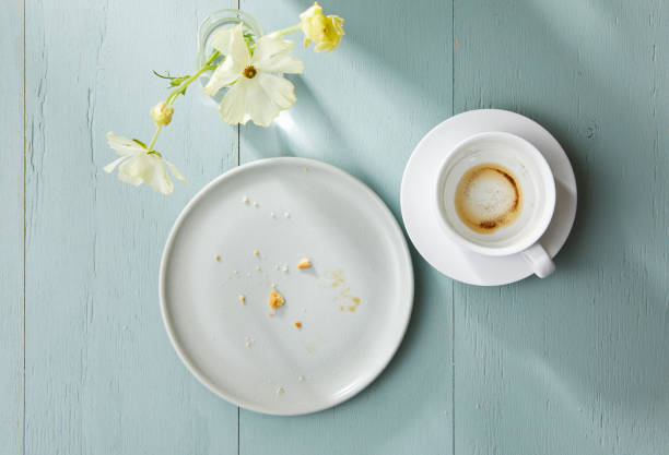 White plate and white coffee cup after eating.