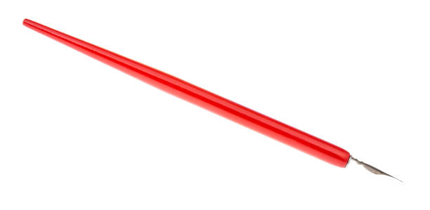 istock side view of dip pen with sharp nib and red holder 1147945706