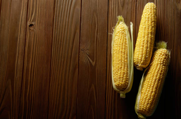 istock Ripe fresh organic sweet corncobs on wooden table 1147947893