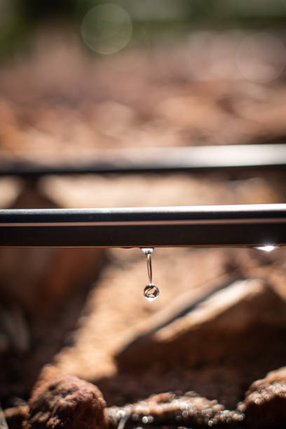 Macro silver water droplets on metal surface