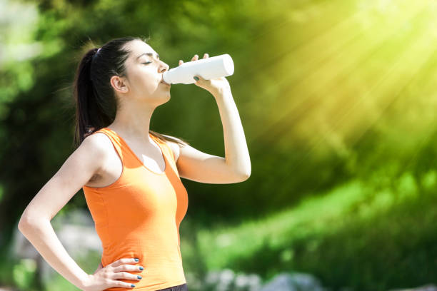 istock Young woman refreshing herself with water 1147960983