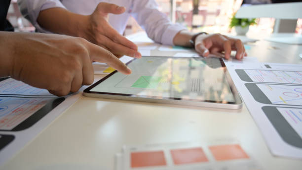 istock Team UI designers design and sketch lay-out with interface on tablet pc 1147961251