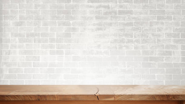 istock Wood table and white brick wall for product dimply montage 1147961263