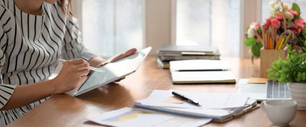 istock Woman is working on tablet on workplace in office 1147961823