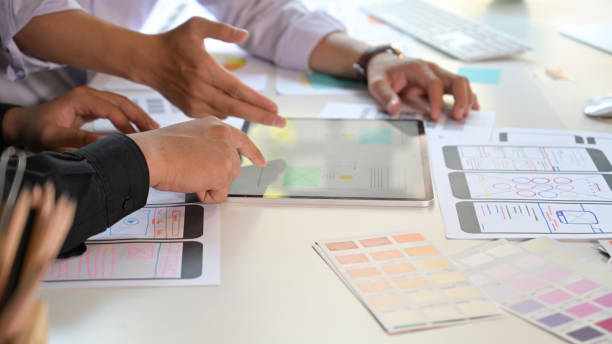 istock Team UI designers design and sketch lay-out with interface on tablet pc 1147961873