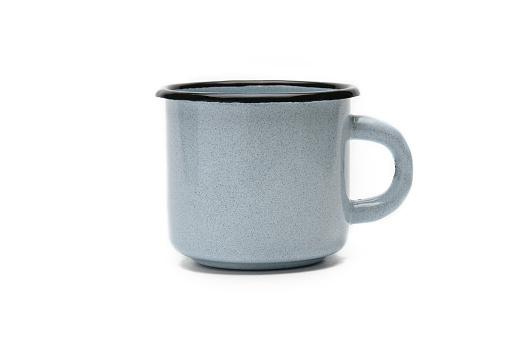 Vintage blue mug made of iron on a white isolated background.Old iron cup.