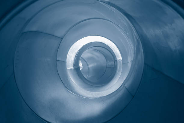 istock Abstract black spiral swirl inside a big shiny metal pipe, 1147963236